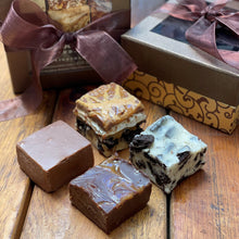 4 squares of fudge in front of a decorative box
