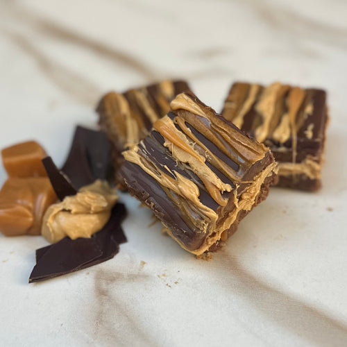 Milk Chocolate and Dark Chocolate Fudges layered with Peanut Butter and Caramel